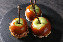 Delicious Caramel Apples With Tree Branches On Slate Plate