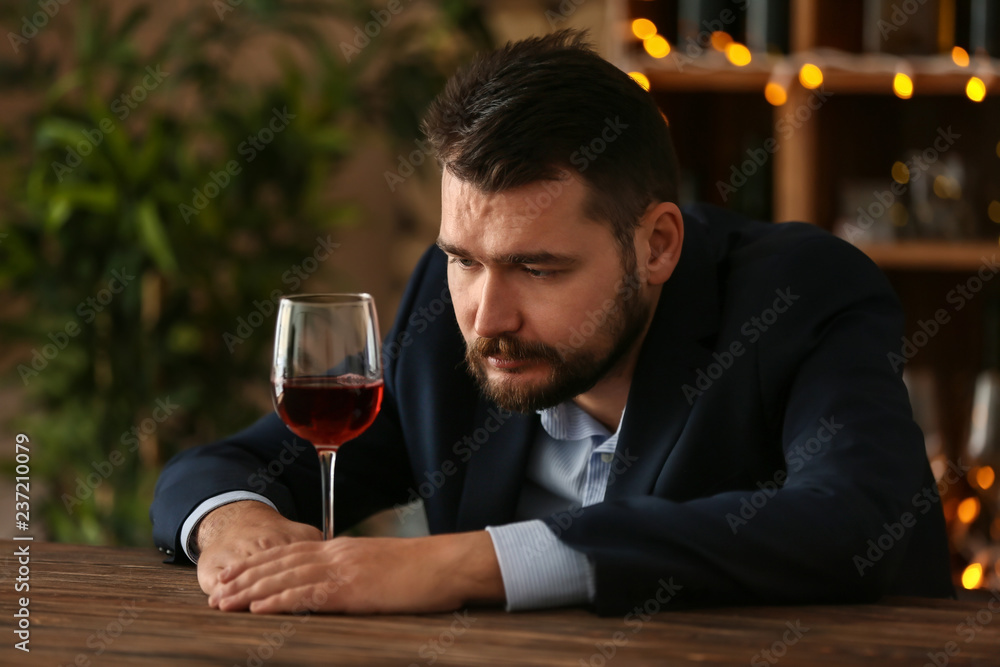 Man drinking wine in bar