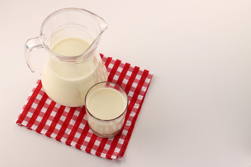 Poster - A jug with milk and a glass on a white background place for text copy space