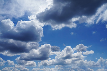 sky with white fluffy and rainy dark clouds after rain. Background texture.  