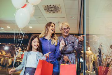 Wall Mural - Mother, adult daughter and granddaughter in shopping mall together