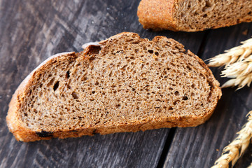 sliced bread with wheat ears on a wooden table