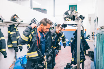 Wall Mural - Firemen preparing for emergency service.