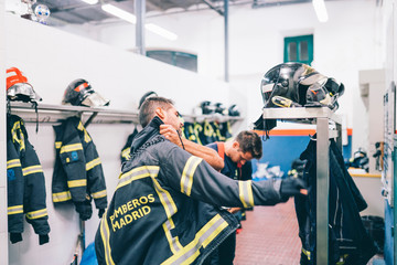 Wall Mural - Firemen preparing for emergency service.