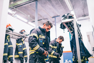 Wall Mural - Firemen preparing for emergency service.