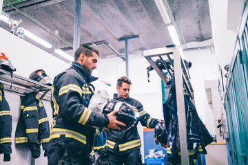 Wall Mural - Firemen preparing for emergency service.