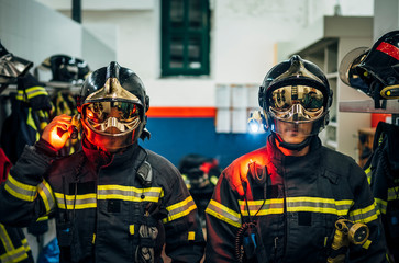 Wall Mural - Two male firefighter posing to camera.