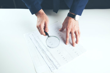 Wall Mural - man hand magnifier and document