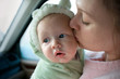 © Erickson Stock - Mother kissing her young baby.