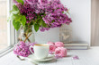 © lizaelesina - Bouquet of lilacs, cup of coffee, homemade marshmallow and stack of books. Romantic spring morning. Selective focus