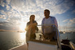© Erickson Stock - Happy mid-adult couple on a boat together on the ocean.