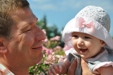 Cute laughing baby and happy father portraits