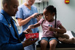 © Sean Locke Photography/Stocksy - Exam: Little Girl Happy To Get Lollipop From Doctor