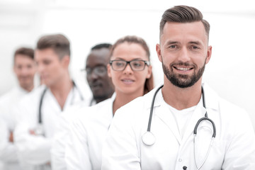 Wall Mural - Team of smiling professional doctors standing together