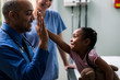 © Sean Locke Photography/Stocksy - Exam: Girl Gives High Five After Exam