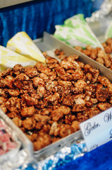 Wall Mural - Candied or glacé walnuts browned and coated with melted sugar for a crunchy glaze, a traditional sweet snack sold at the Nürnberger Christkindlesmarkt, a Christmas market in Nürnberg, Bavaria, Germany