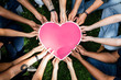 © Rawpixel.com - Group of people holding a pink heart icon