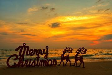 Happy new year concept, Merry Christmas put no sand beach in sunset.