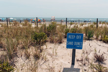 Sign With Keep Off Sand Dunes By An Ocean Beach