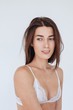 © Liliya Rodnikova/Stocksy - Simple portrait of young beautiful brunet in lace bra on white background