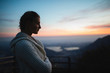 © michela ravasio/Stocksy - Girl enjoying the sunset alone in the mountain