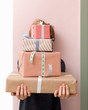 © Duet Postscriptum/Stocksy - Woman behind gift boxes