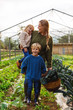 © BONNINSTUDIO/Stocksy - Mother and her kids smiling together on their orchard.