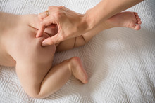 Hand Pinching Baby's Butt