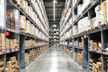 Large Warehouse Logistic Or Distribution Center. Interior Of Warehouse With Rows Of Shelves With Big Boxes.