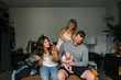© Rob and Julia Campbell/Stocksy - Young family with rowdy kids, crying baby and laughing parents
