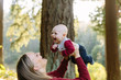 © Leah Flores/Stocksy - Mom Lifting Baby up in the Air