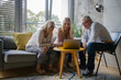 © Mosuno/Stocksy - Grandparents and Granddaughter Looking at Laptop