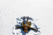 © AnastazjaSoroka - The girl is making an angel in the snow.