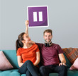 © Rawpixel.com - Young couple holding a pause button icon