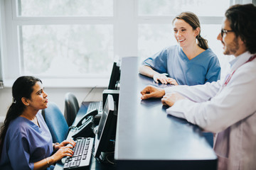 Wall Mural - Medical team having a conversation at the reception