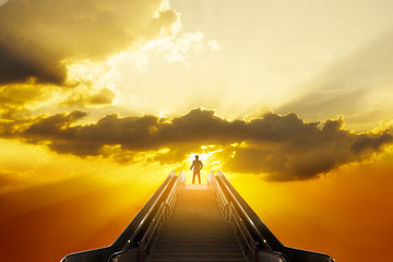 Businessman stand on top of staircase with sun light on open sky, success businessman conceptual