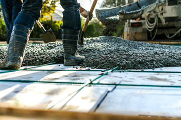 mixer track pouring wet cement to the civil building foundation. construction workers in the process