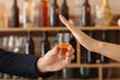 © Pixel-Shot - Man with glass of whiskey and woman refusing to drink in bar