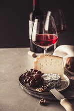 Red Wine And Cheese Plate With Fruits And Nuts