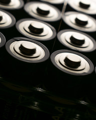 Closeup of pile of used alkaline batteries. Close up colorful rows of selection of AA batteries energy abstract background of colorful batteries. 