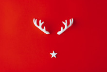 Reindeer Antlers With Star On Red Background. Christmas Minimal Greeting Card.