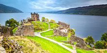 Urquhart Castle With Dark Cloud Sky And Loch Ness In The Background