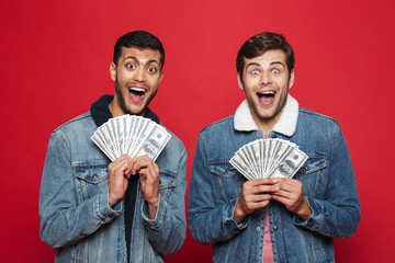 Canvas Print - Two cheerful young men standing isolated over red