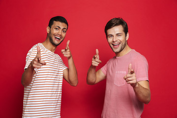 Sticker - Two cheerful young men standing isolated over red