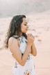 © Tetiana - Young beautiful Indian woman standing and dreaming in the desert