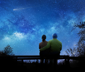 Wall Mural - couple watching the stars in night sky