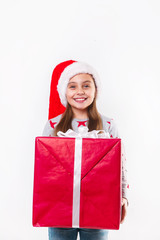 Smiling funny child in Santa red hat holding Christmas gift in hand. Christmas concept.