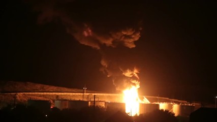 fire at the refinery at night.