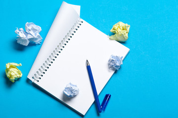 Wall Mural - Top view workspace mockup on blue background with notebook, pen