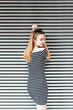© Westend61 - Young woman wearing striped dress